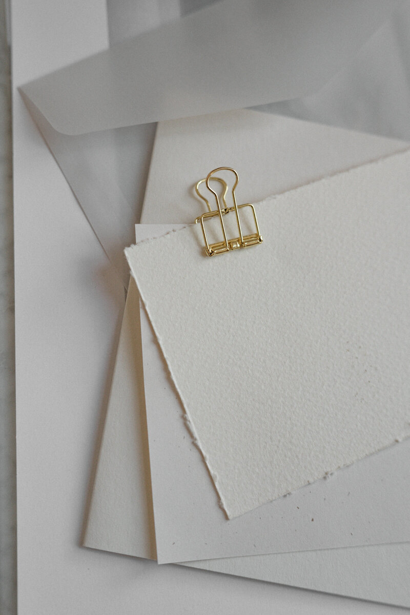 a stack of paper agreements for UGC content between brands and creators